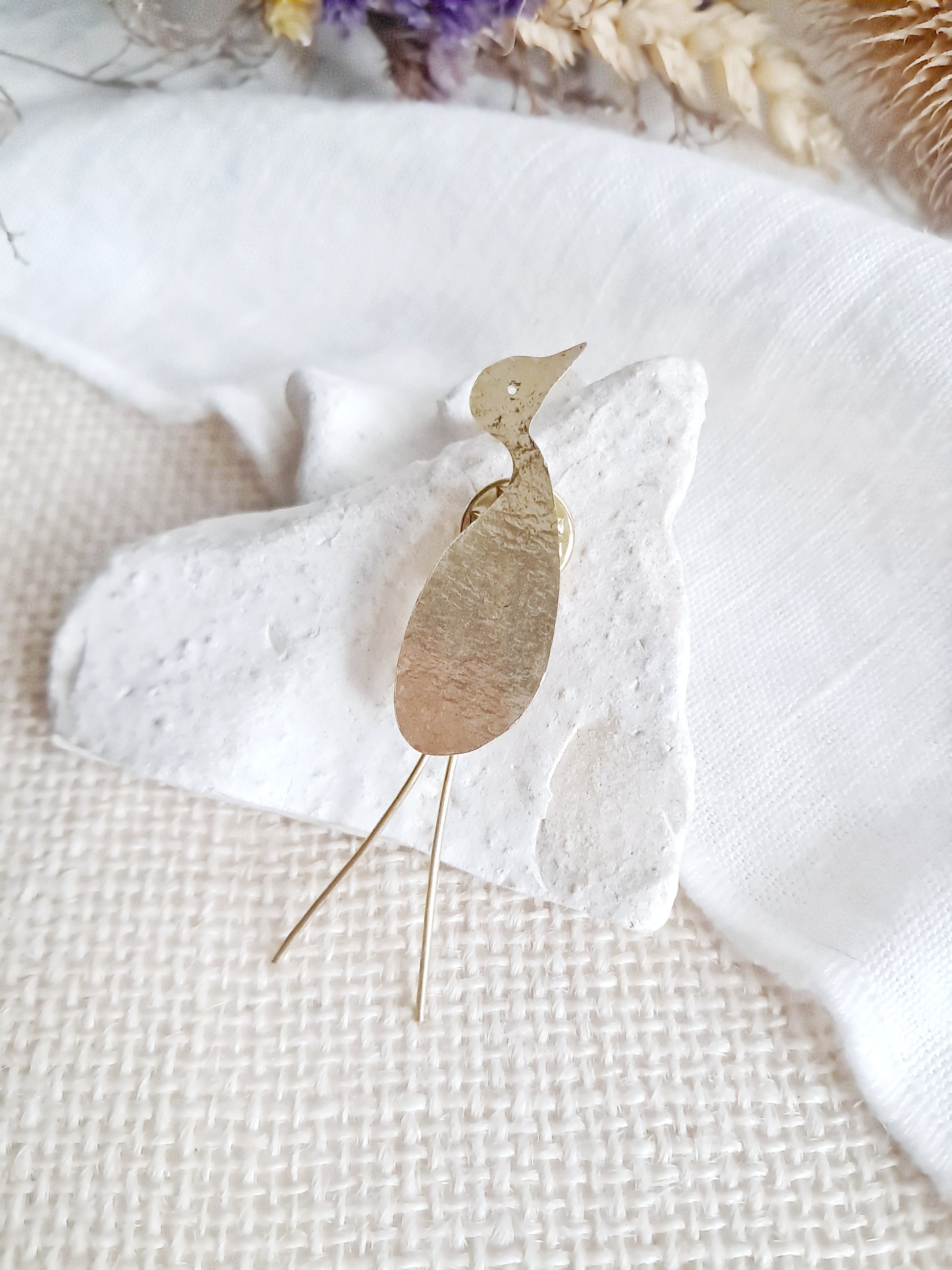 Pin's grue texturée en laiton